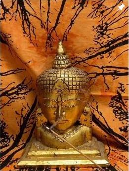 Golden Buddha statue with incense smoke inside Ants