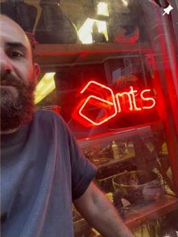 The glowing Ants neon sign inside the shop in Hamra